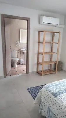 a bathroom with a sink and a toilet in a room at Apartamentos La Fuente Ribadeo in Ribadeo