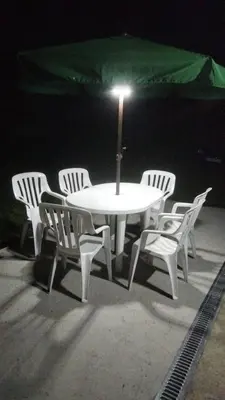 a white table and chairs with an umbrella at Apartamentos La Fuente Ribadeo in Ribadeo