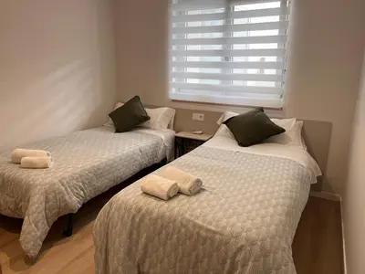 two beds sitting next to each other in a room at Valdeflores flats in Viveiro