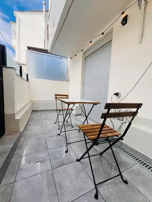 a group of tables and chairs in a room at Valdeflores flats in Viveiro