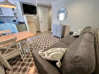 a living room with a couch and a table at Valdeflores flats in Viveiro