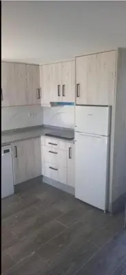 a kitchen with white cabinets and white appliances at Pepiño de Tomonte in Atrave
