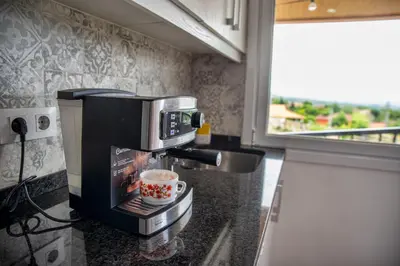 a kitchen counter with a coffee maker and a cup of coffee at Esperanza de a Trabe in Atrave