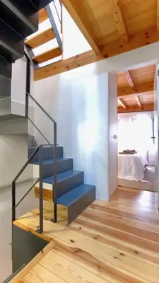 a staircase in a room with a bed at The Cliffs - Casa Catuxa in Viveiro