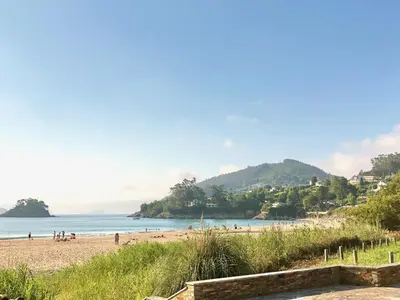 a view of a beach with people on it at The Cliffs - Casa Catuxa in Viveiro