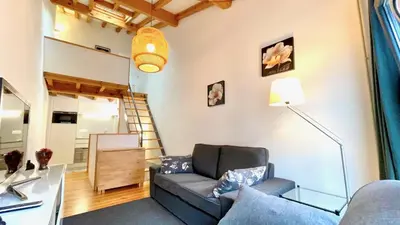 a living room with a couch and a staircase at The Cliffs - Casa Catuxa in Viveiro
