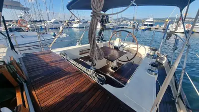 a boat with a wooden deck in the water at Velero Clásico de madera in Sada
