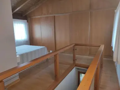 a small room with a bed and a balcony at Casa Merteira in Ourense