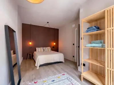 a bedroom with a bed and some shelves at La Fantástica Pontedeume 3 in Puentedeume