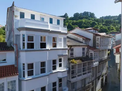 an overhead view of a white building in a city at La Fantástica Pontedeume 3 in Puentedeume