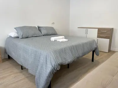 a bedroom with a bed with two towels on it at Céntrico apartamento muralla 1 in Lugo