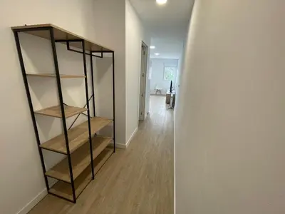 a room with a book shelf and a hallway at Céntrico apartamento muralla 1 in Lugo