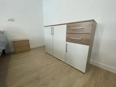a large white cabinet in a room with wooden floors at Céntrico apartamento muralla 1 in Lugo