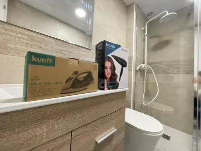 a box is sitting on a shelf in a bathroom at Céntrico apartamento muralla 1 in Lugo