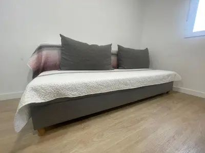 a bed with two pillows on it in a room at Céntrico apartamento muralla 1 in Lugo