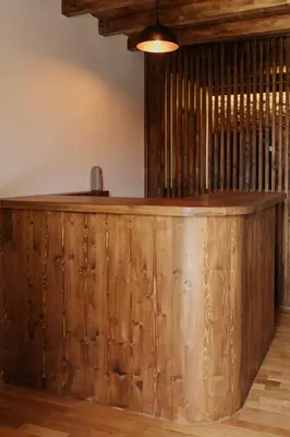 a wooden bar in a room with a ceiling at Tres Portas in Licín
