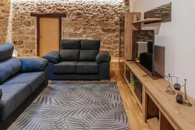 a living room with a couch and a television at Tres Portas in Licín