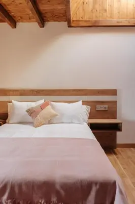 a bedroom with a large bed with white pillows at Tres Portas in Licín