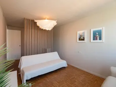 a bedroom with a white bed and a chandelier at La Fantástica Pontedeume 4 in Puentedeume
