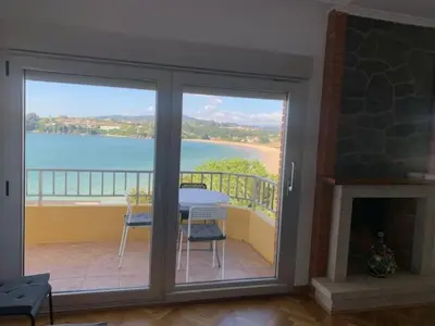 a balcony with a table and a view of the ocean at Piso Miño con vistas in Miño