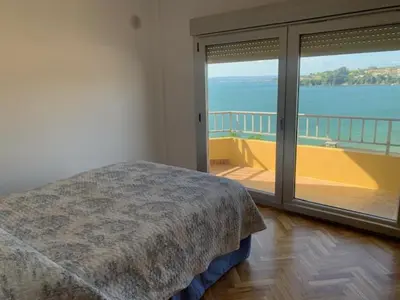 a bedroom with a bed and a view of the ocean at Piso Miño con vistas in Miño