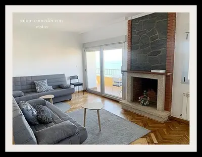 a living room with a couch and a fireplace at Piso Miño con vistas in Miño