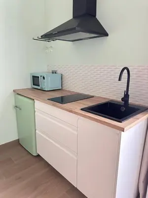 a kitchen counter with a sink and a microwave at Ensueño in Molinaseca