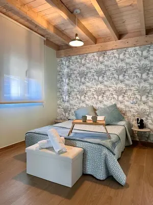 a bedroom with a bed with a table on it at Ensueño in Molinaseca