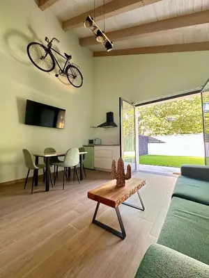 a living room with a bike hanging from the ceiling at Ensueño in Molinaseca