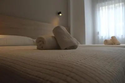 a hotel room with two towels on a bed at Apartamentos Rego Foz in Foz