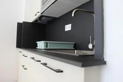 a kitchen with a sink and a counter top at Apartamentos Rego Foz in Foz