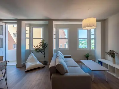 a living room with a couch and some windows at La Fantástica Pontedeume 2 in Puentedeume