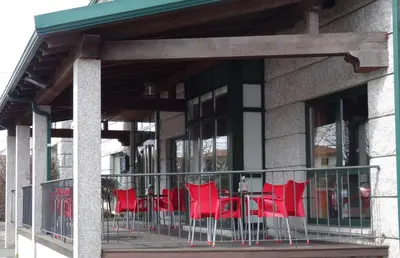 a group of red chairs sitting on a balcony at Hotel Akelarre in Santiago de Compostela