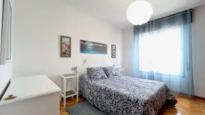 a small bedroom with a bed and a window at The Cliffs - Brisa Marina in Viveiro