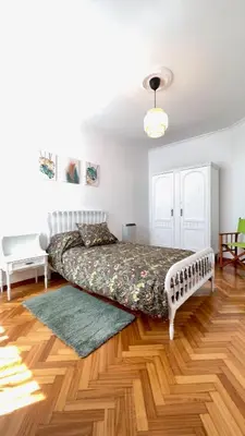 a bedroom with a bed and a wooden floor at The Cliffs - Brisa Marina in Viveiro