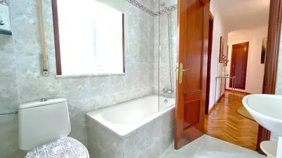 a bathroom with a tub and a toilet and a sink at The Cliffs - Brisa Marina in Viveiro