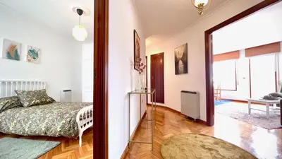 a bedroom with a bed and a door to a hallway at The Cliffs - Brisa Marina in Viveiro