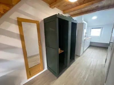 a green cabinet in a room with a mirror at Céntrico estudio muralla romana in Lugo