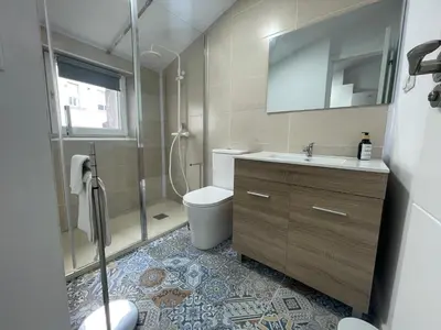 a bathroom with a toilet and a sink and a shower at Céntrico estudio muralla romana in Lugo