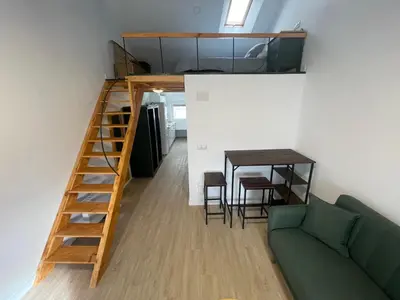 a living room with a couch and a table at Céntrico estudio muralla romana in Lugo