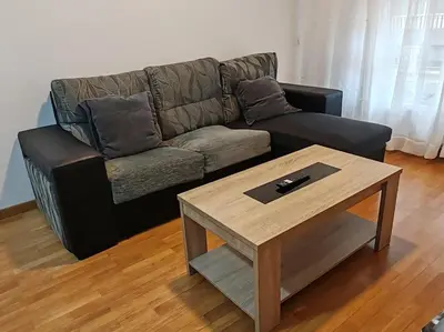 a living room with a couch and a coffee table at Os Garitos in Ribadeo
