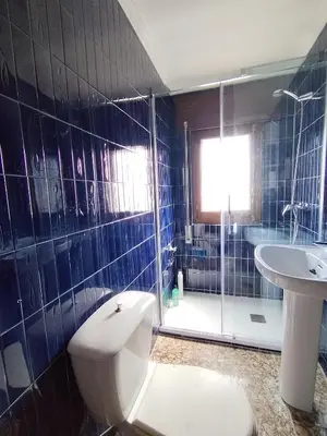 a bathroom with a toilet and a sink and a shower at Covas Beach Ocean in Covas