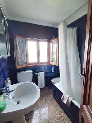 a bathroom with a sink and a tub and a toilet at Covas Beach Ocean in Covas