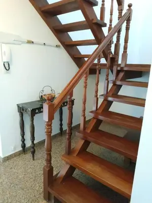 a wooden staircase with a table next to it at Covas Beach Ocean in Covas