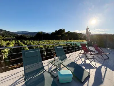 a group of chairs and a table on a patio at A Finca Da Toñita in Ribadavia