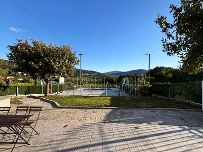 a park with two benches and a basketball court at A Finca Da Toñita in Ribadavia