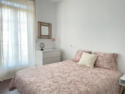 a bedroom with a bed and a mirror and a window at A Finca Da Toñita in Ribadavia
