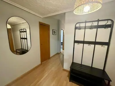 a room with a mirror and a bench in it at Piso Turístico Felipe Herce in Ponferrada
