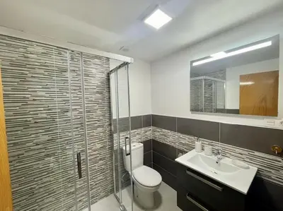 a bathroom with a toilet and a sink and a shower at Piso Turístico Felipe Herce in Ponferrada