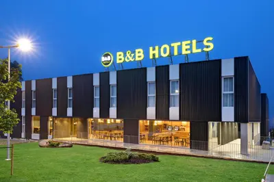 a building with a bbc hotels sign on it at B&B HOTEL Santiago Milladoiro in Milladoiro